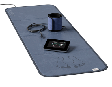 Wellness mat with a device, foot massager, and control panel.