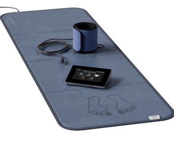 Wellness mat with a device, foot massager, and control panel.